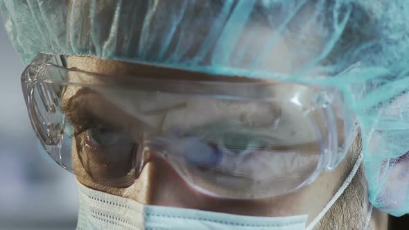Medical Scientist in Protective Glasses Working in Laboratory, Face Close Up