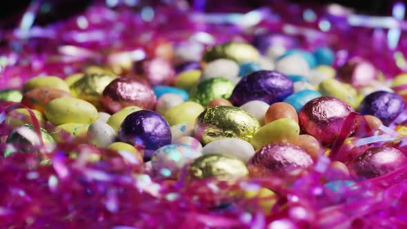 Rotating shot of colorful Easter candies on a bed of easter grass - EASTER