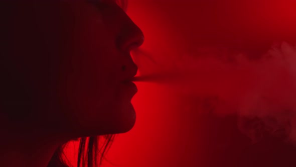 Extreme Closeup Female Blowing Steam of Smoke Enjoying Smoking