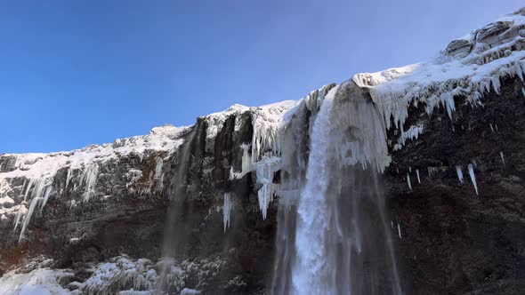 Spectacular Seljalandsfoss Waterfall in Winter Iceland, Low Angle Tilt View of Cascade of the Falls