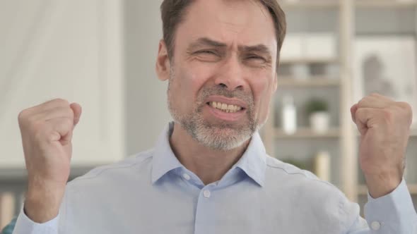 Portrait of Frustrated Senior Aged Businessman Reacting to Loss