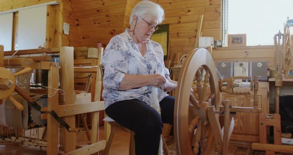 Senior woman operating weaving machine 4K 4k