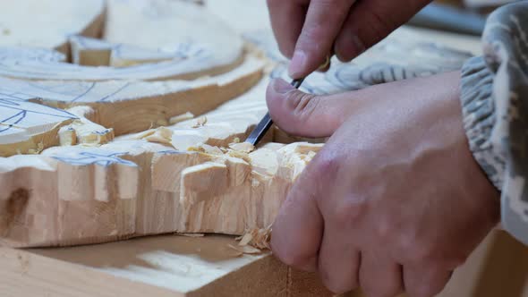 Wood Carver Creates a Basrelief From Wood Closeup Hands