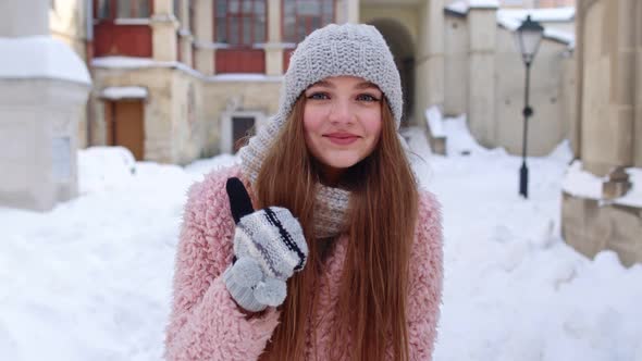 Cheerful Positive Young Woman Smiling To Camera Showing Thumb Up While Standing Outdoor in Winter