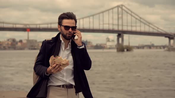 Busy Businessman Lunch Eating Sandwich And Talking On Phone. Manager Hurry To Work. Sandwich Food.