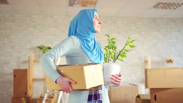 Portrait Young Muslim Woman in a Hijab with a Flower and a Box in Her Hands