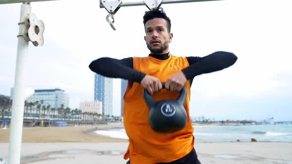 Man training at the beach outdoor gym