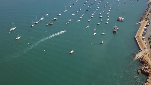 Yachts and sailboats in port of a marina of a seaside community.