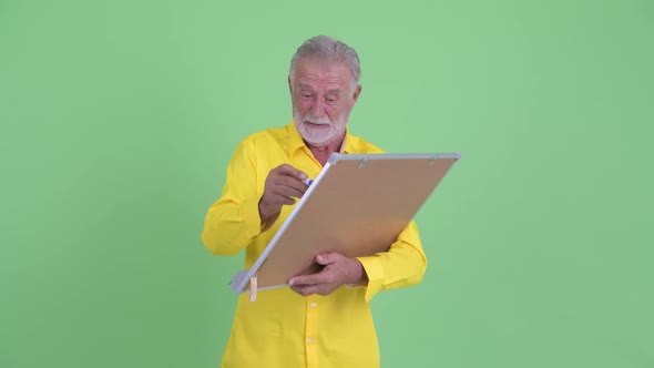 Funny Senior Bearded Businessman Holding White Board with Help Sign