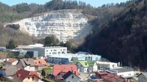 Revealing Traditional Slovenian Village and Steep Mountain Background, Aerial Backward