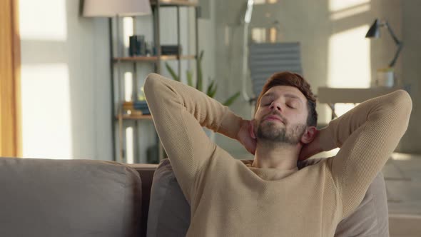 Young guy relaxes on the sofa in a calm atmosphere alone