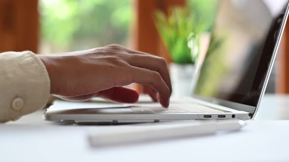 4K Footage Close-up of the hand that is operating the laptop keyboard.