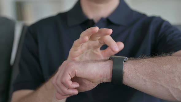 Close Up of Hands of Man Using Smart Watch