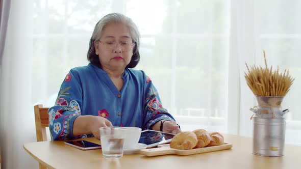 Senior woman use smart watch payment in coffee shop