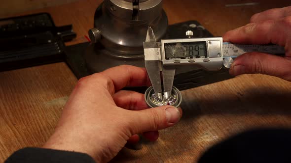 Jeweler Measures Zirconium Gemstones