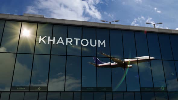 Airplane landing at Khartoum Sudan airport mirrored in terminal