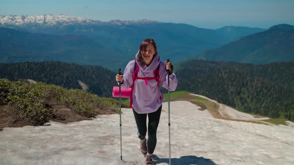 Tourist Woman at Top of Mountain Climbing with Backpack and Trekking Poles