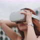 A young woman trying on virtual reality glasses - VideoHive Item for Sale