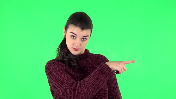 Woman Talking and Pointing Side Fingers for Something, with Copy Space. Green Screen