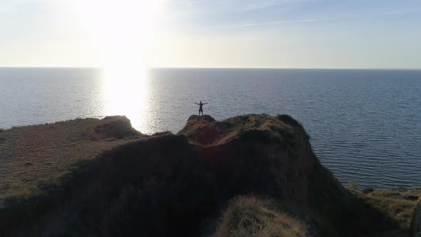 Outdoor Sports Practice, Silhouette of Men on Slope By Sea with Brilliant Water Against Sky in