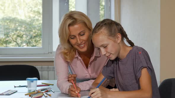 Mature Beautiful Woman Enjoying Drawing with Her Little Student