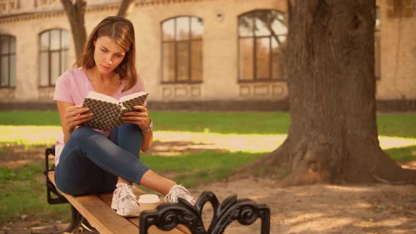 Young Woman Studying Near College