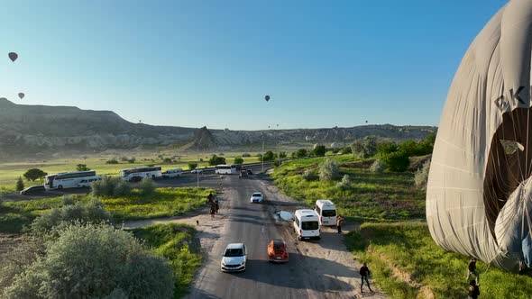 4K Aerial view of Goreme. Colorful hot air balloons fly over the valleys.