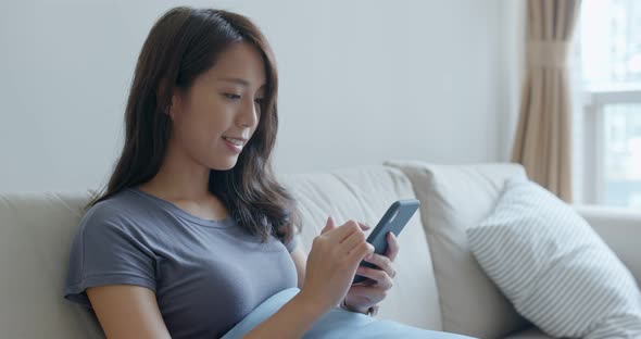 Young woman use of mobile phone at home