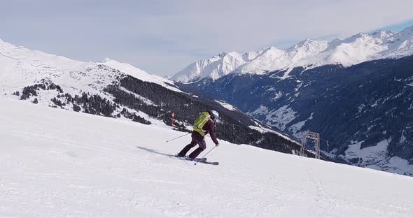 High speed skiing in the tyrolean mountains on a perfect groomed ski slope. Professional follow came