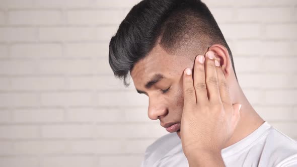 Young Man Having Ear Pain Touching His Painful Ear