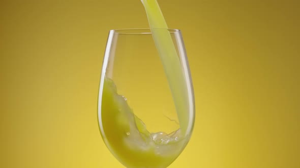 A Stream of Freshly Squeezed Natural Orange Juice Poured Into a Glass