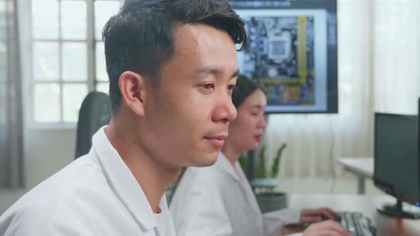 Development Facility: Asian Male Engineer Works On Computer With Cad Programming Software