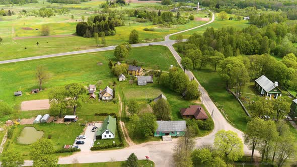 Aerial View of Rural Village in Countryside of Lithuania, Homes and Farming Land on Summer Season, D