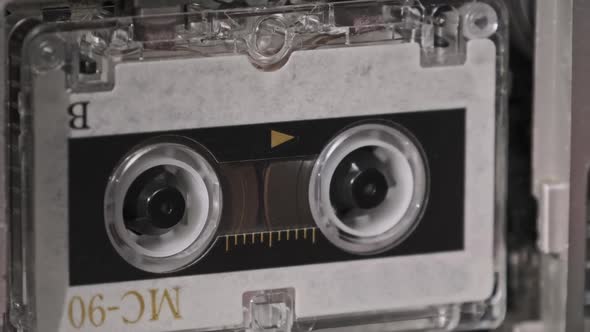 Vintage Audio Tape with a Blank Label Spinning in Cassette Recorder Closeup