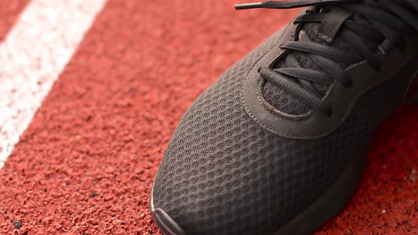 Athlete Tying Shoe Laces Before a Workout