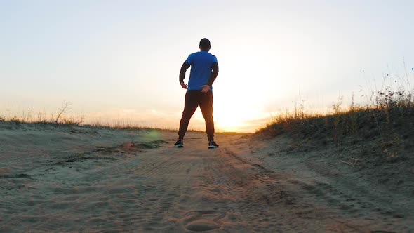 Running Man Silhouette in Sunset Time. Outdoor Cross-country Running. Athletic Young Man Is Running