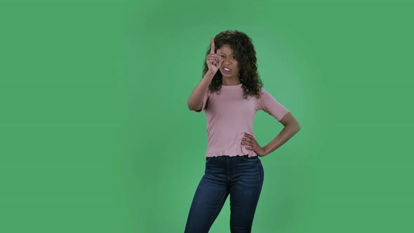 Portrait of Beautiful African American Young Woman Is Looking at Camera and Strictly Gesturing with