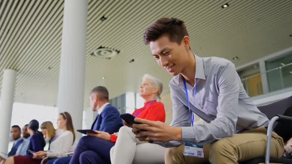 Asian Businessman using mobile phone in the business seminar 4k