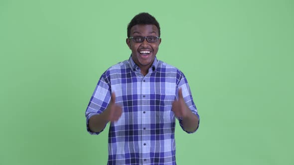 Happy Young African Hipster Man Giving Thumbs Up and Looking Excited