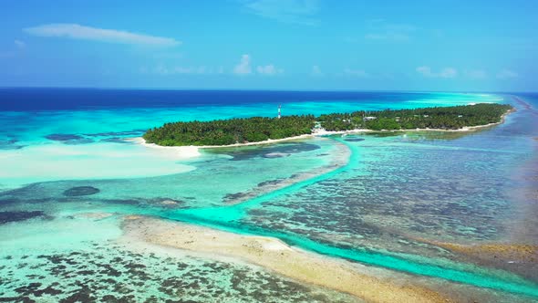 Wide flying island view of a sunshine white sandy paradise beach and blue water background in colour