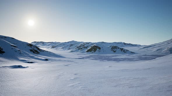 Aerial Landscape of Snowy Mountains and Icy Shores in Antarctica