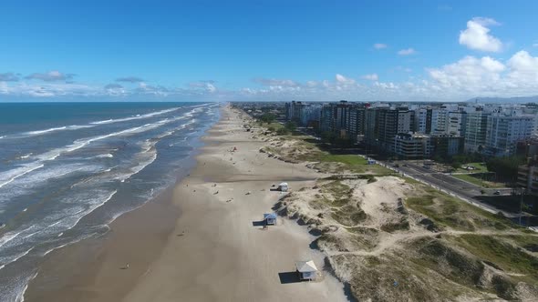 Beach and city, aerial scene in 4k, Capao da canoa city, south of Brazil.