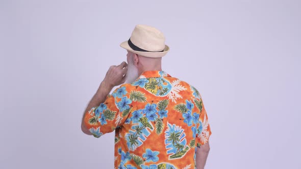 Rear View of Mature Bearded Tourist Man Pointing Finger