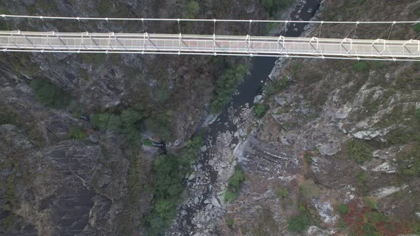 Suspension Bridge with River in Background