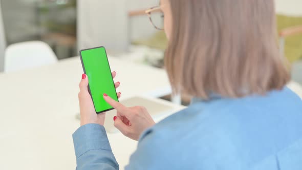 Young Woman using Smartphone with Chroma Screen