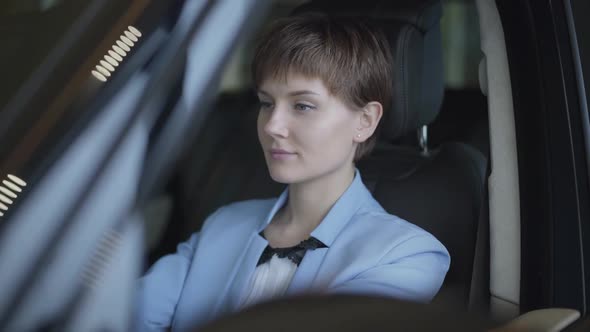 Portrait of a Successful Cute Young Girl with Short Dark Hair Dressed in a Stylish Suit