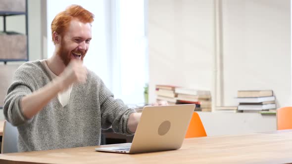 Excited Man Celebrating Success, Working on Laptop