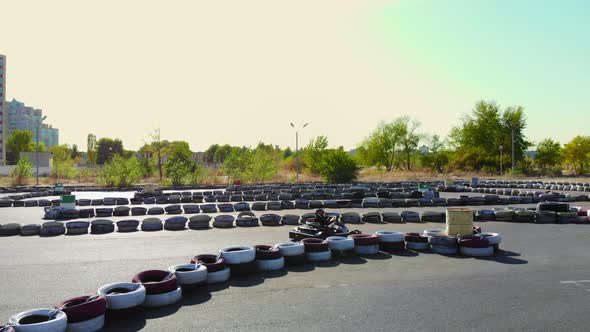 Young Go Cart Race on Circuit Outdoors. There Are Safety Barriers Made of Old Wheels . Ten Years Old