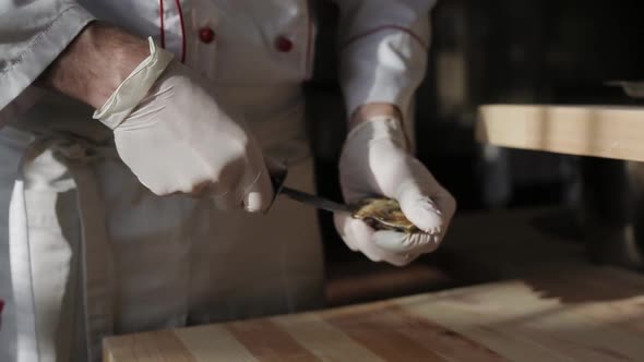 The Chef at the Restaurant Opens Oysters