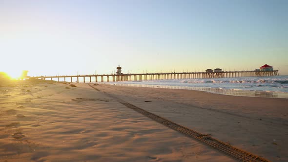 A 4k time-lapse at sunrise with the pier in the background moving from left to right at sunrise as f